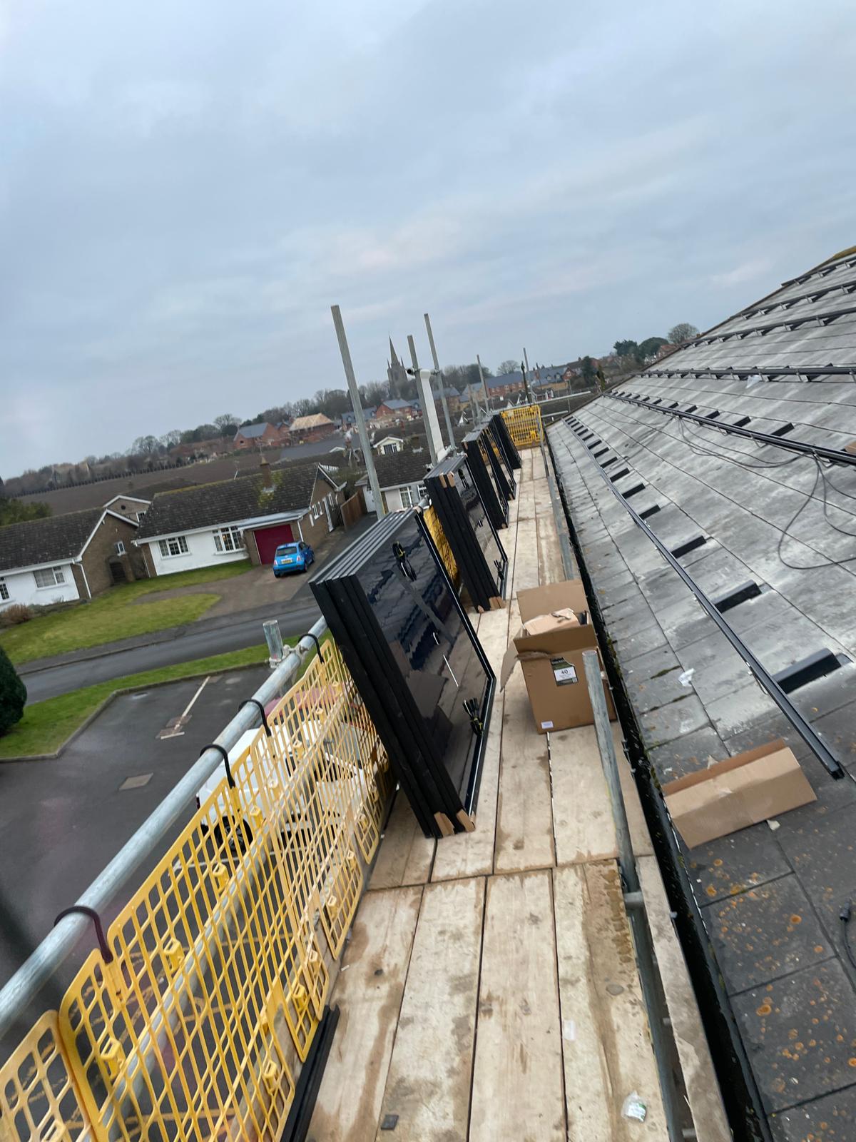 Commercial solar installation equipment and inverter setup on scaffolding at Swineshead Medical Group