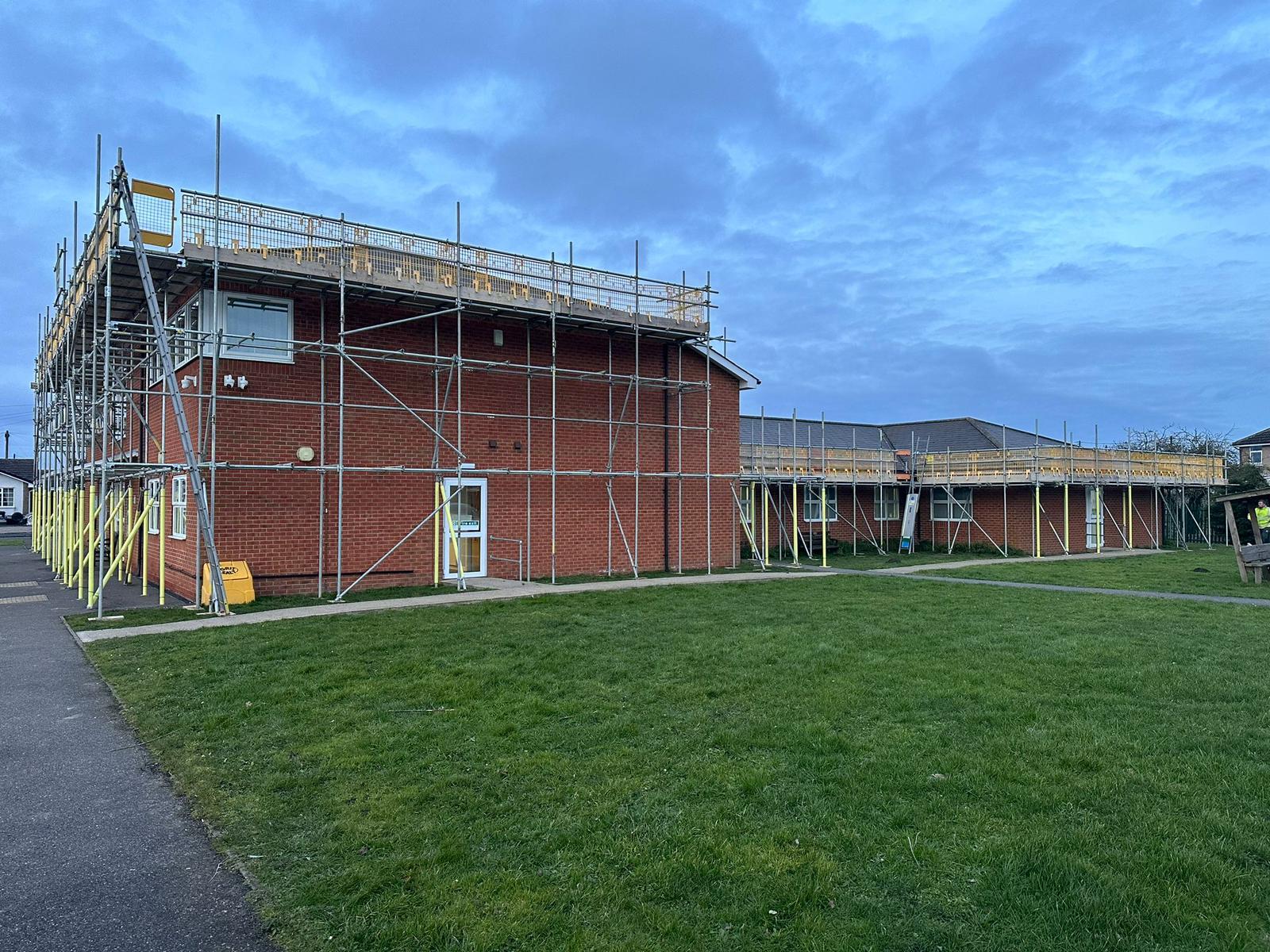 Commercial solar installer working on complete building solar panel system at Swineshead Medical Group