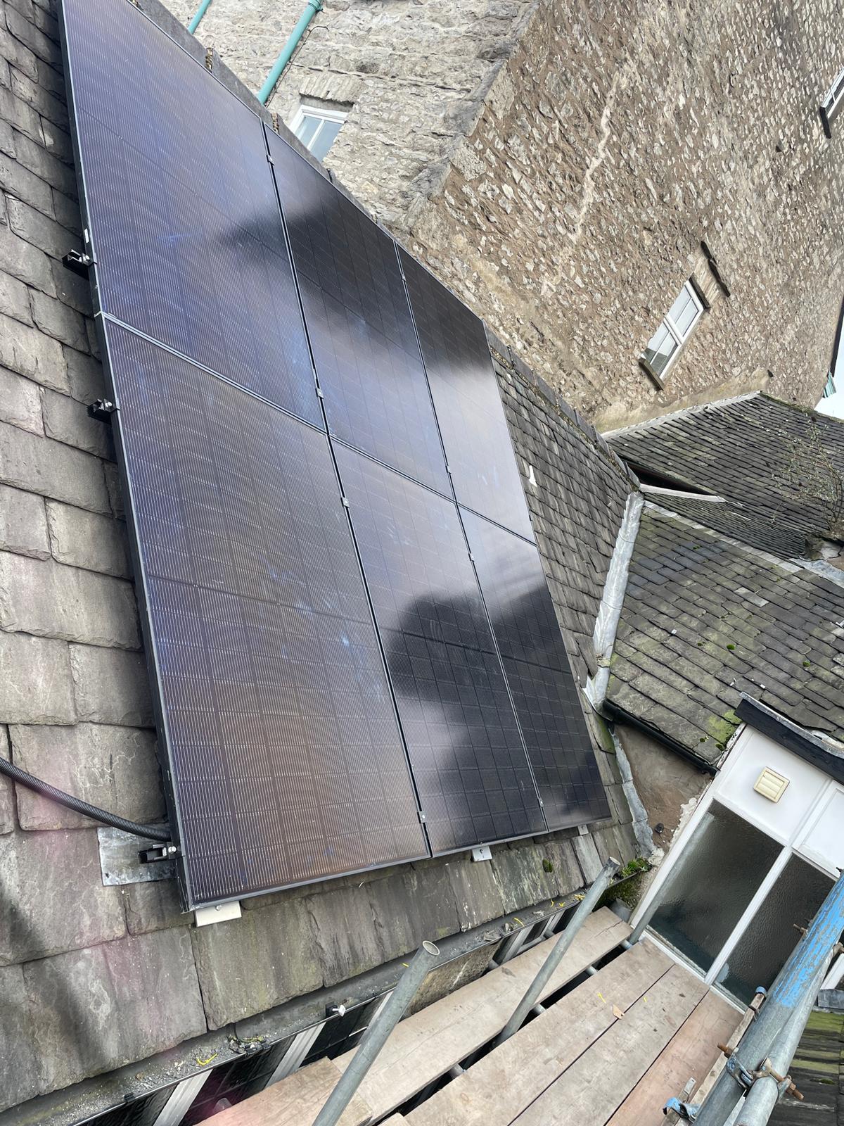 Aerial view of completed Kendal commercial solar installation on multiple roof sections