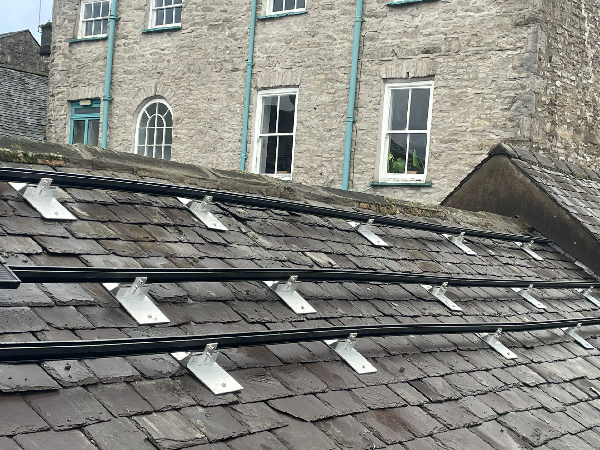 Slate roof mounting rails installation on Kendal listed building showing heritage-compliant fixings