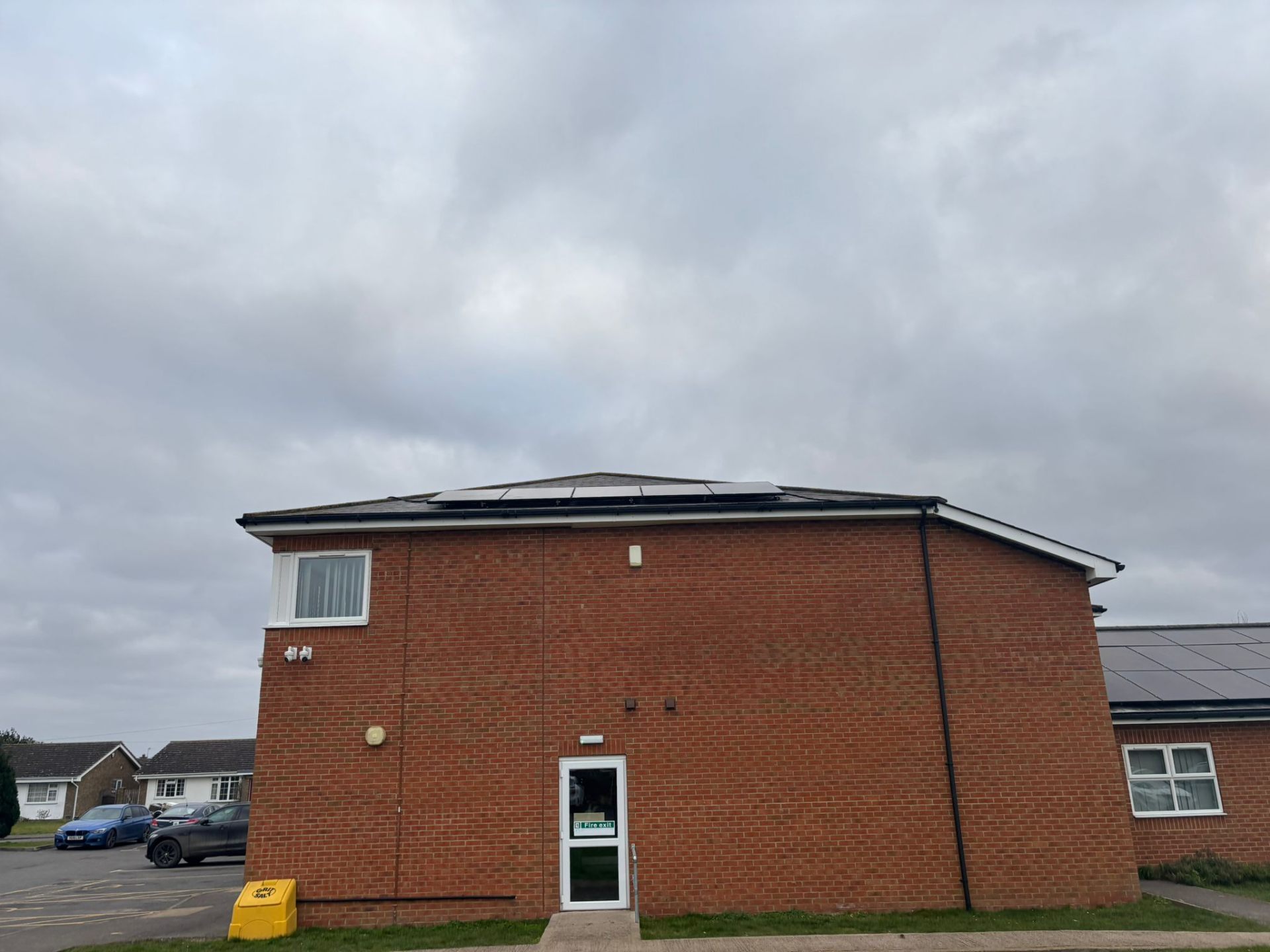 Commercial solar installer finished building side view showing solar panels on Swineshead Medical Group
