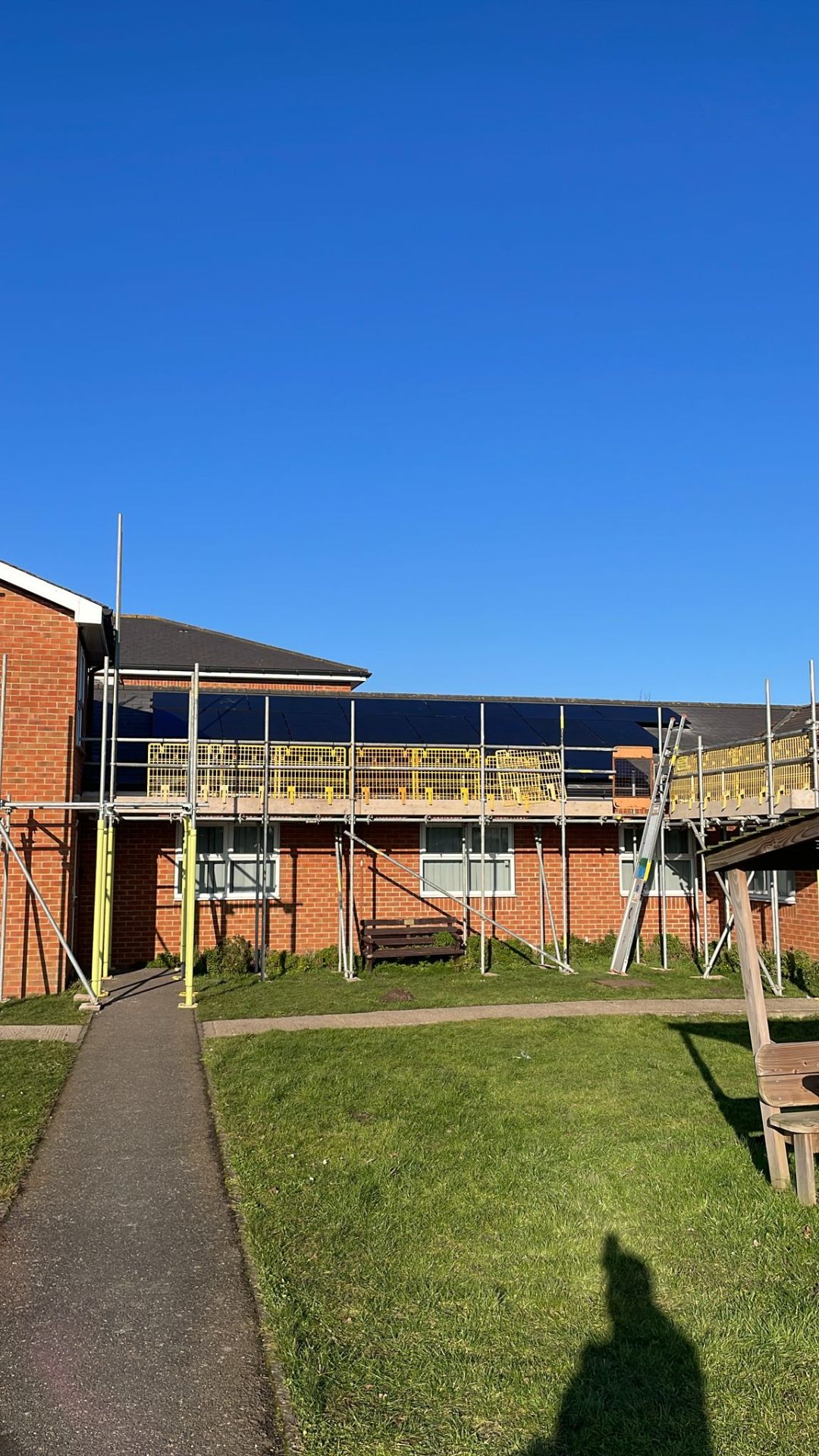 Commercial solar installation scaffolding setup at Swineshead Medical Group building